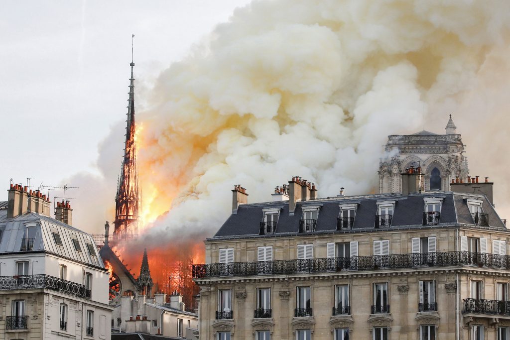 Flames and smoke billow from the Notre Dame Cathedral after a fire broke out in Paris on 15 April 2019. Officials said the cause was not clear, but that the fire could be linked to renovation work. Photo: Benoit Tessier/Reuters.