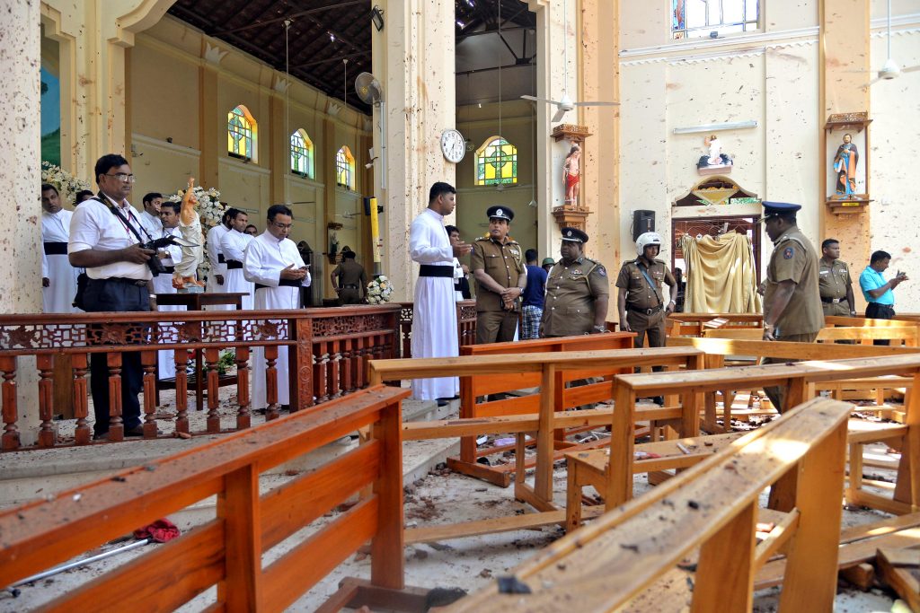 Police officials look over the scene after a bombing where at least 200 people were killed and hundreds more injured on Easter Sunday in Sri Lanka when attackers unleashed an apparently coordinated series of bombings that simultaneously targeted Christian churches and luxury hotels. Photo: Reuters/CNS.