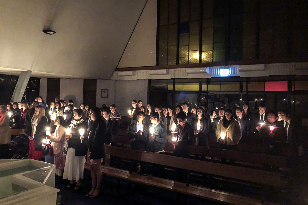 Parishioners of Mirrabooka hold their candles during the Liturgy of Light at the celebration of the Easter Vigil Mass. Photo: Supplied.