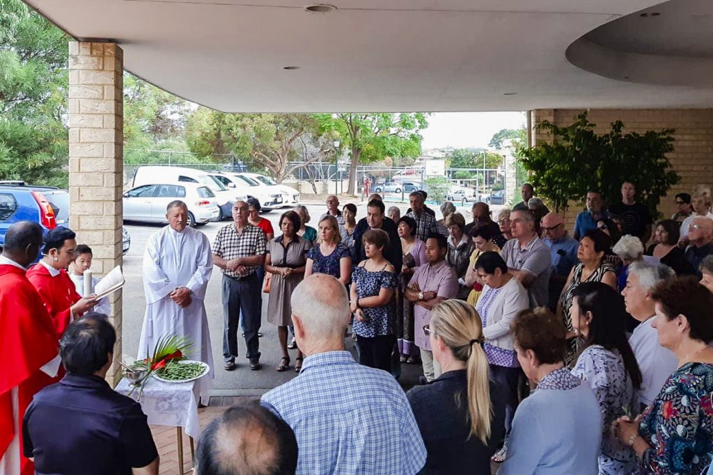 St Luke Parish gathered outside the Church for their Palm Sunday at the 8am mass on 14 April 2019. Photo: Keith Perreau.