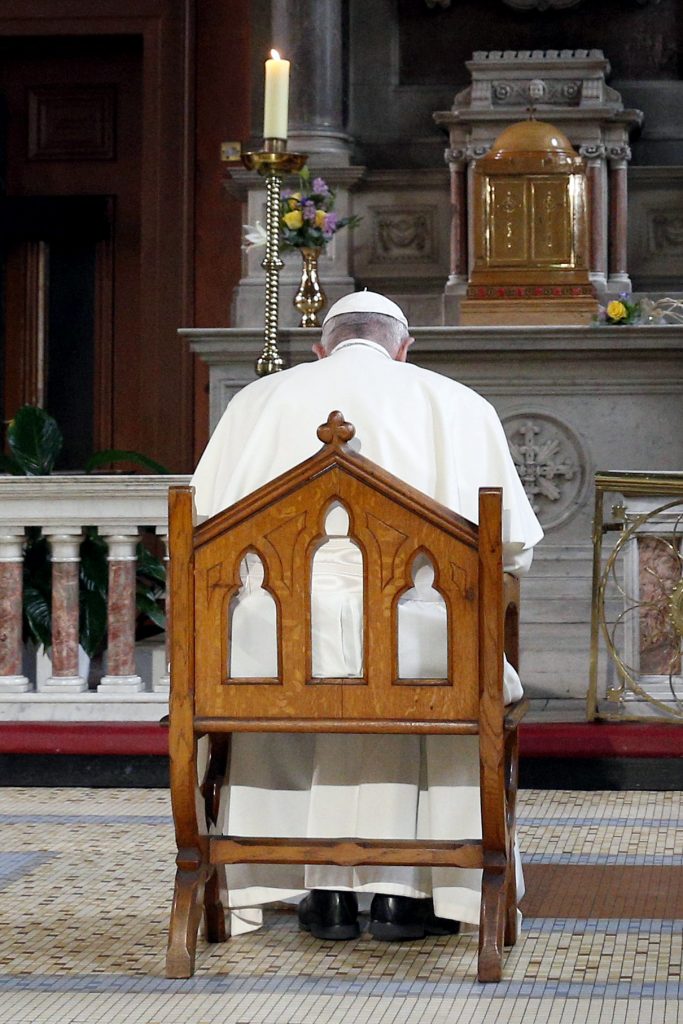 Pope Francis prays in front of a candle in memory of victims of sexual abuse as he visits St Mary's Pro-Cathedral in Dublin on 25 August 2018. Pope Francis has revised and clarified norms and procedures for holding bishops and religious superiors accountable in protecting minors as well as in protecting members of religious orders and seminarians from abuse. Photo: Paul Haring/CNS.