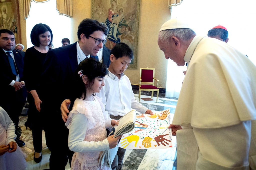Pope Francis talks with young people during an audience with a delegation from the Institute of the Innocents, a Florence-based organisation dedicated to caring for children. Photo: Vatican Media/CNS.