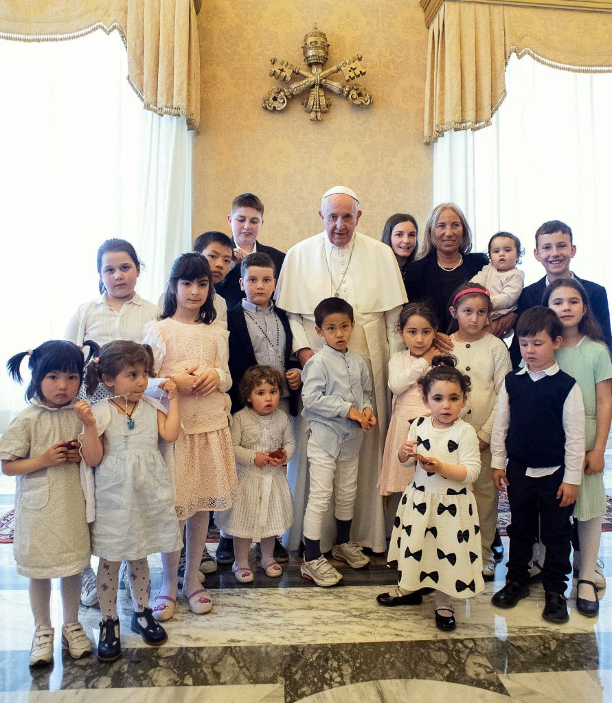 Pope Francis poses during an audience with a delegation from the Institute of the Innocents, a Florence-based organisation dedicated to caring for children. Photo: Vatican Media/CNS.