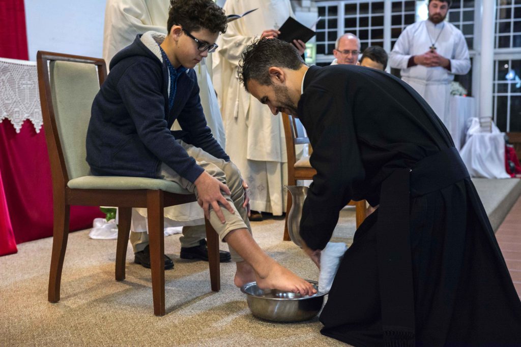 Deacon Chris de Sousa CRS washes the feet of his nephew as part of his Solemn Profession of Vows on 4 August 2018 at Spearwood Parish. Photo: Feby Plando.
