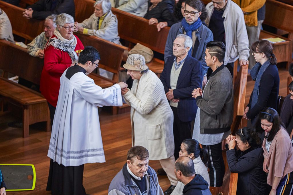 A parishioner is seen receiving the Body of Christ at the Trinity Sunday Mass held at St Marys Cathedral on 16 June. Photo: Ron Tan.