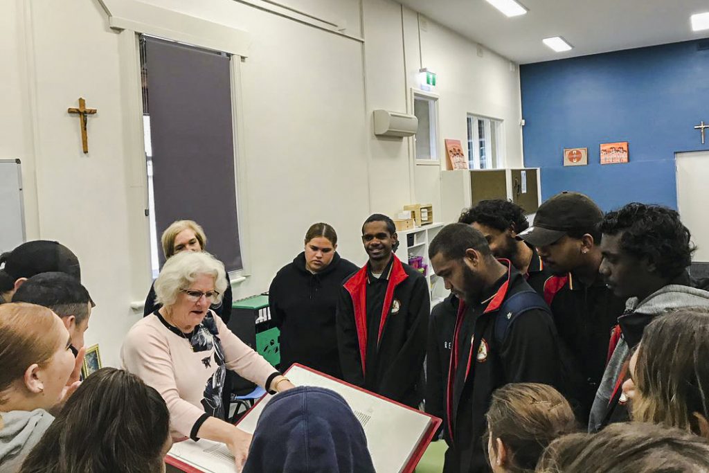 Dr Angela McCarthy explains and displays the Saint John’s Bible, the first handwritten Bible in over 500 years, to a group of Year 12 students. Photo: Supplied.
