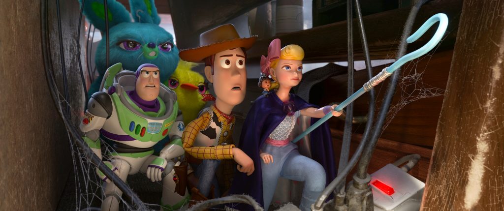 Animated characters Buzz Lightyear (voiced by Tim Allen), Woody (voiced by Tom Hanks), and Bo (voiced by Annie Potts) appear in the movie "Toy Story 4". Photo: Disney/CNS.