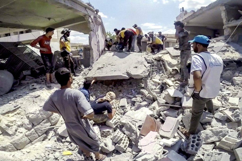 A member of the White Helmets, also known as the Syria Civil Defense, uses a saw on rubble after an airstrike in this screen grab taken from a social media video said to be taken in Idlib, Syria on 16 July 2019. Pope Francis urged Syrian President Bashar Assad to put an end to his nation's eight-year-long conflict and seek reconciliation for the good of the country and its vulnerable people. Photo: White Helmets/Reuters.