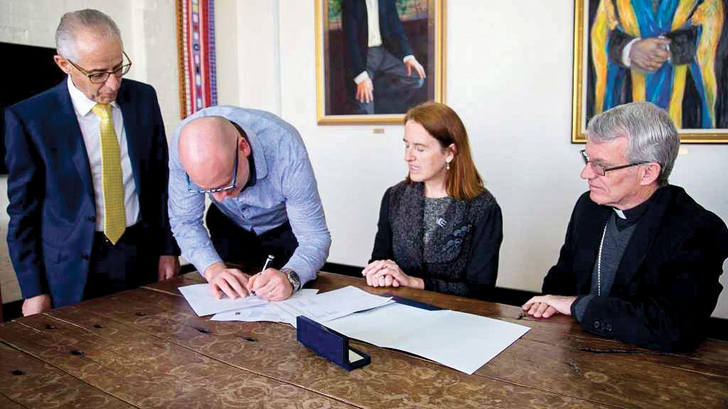 Dr Martin Drum signs the UNDA Agreement Photo: Amy Gibbs.
