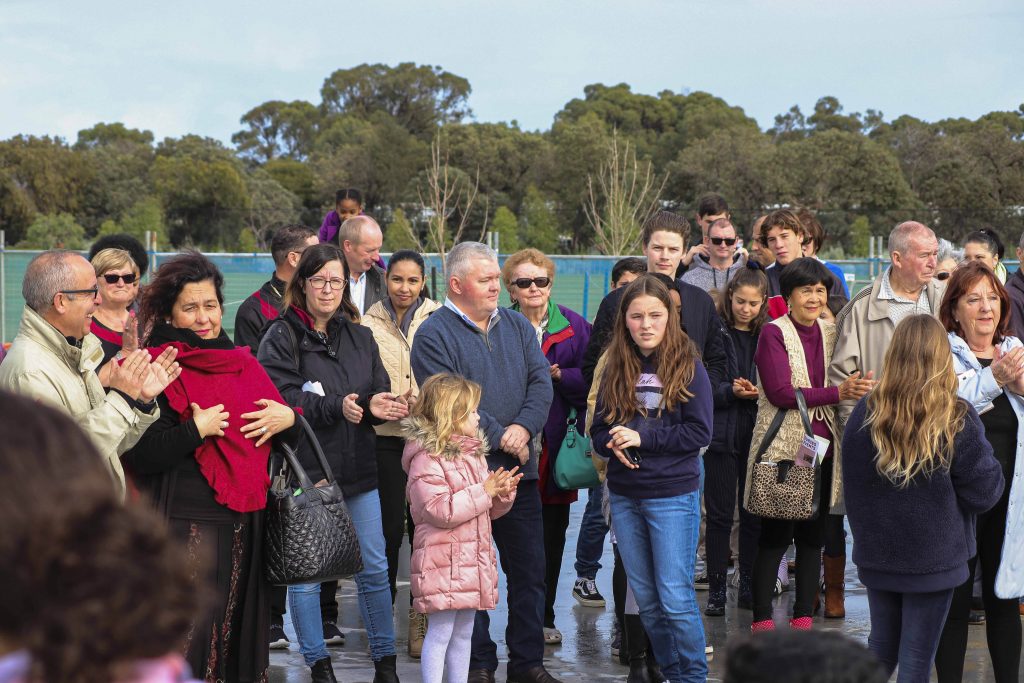Parishioners stand on the foundation of their new upcoming Church after Mass on 7 July. Photo: Supplied.