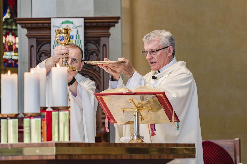 Perth Archbishop Timothy Costelloe (right) consecrates the Blessed Sacrament alongside St Mary’s Cathedral Assistant Priest Fr CJ Millen on the Feast of Don Bosco, 31 January 2019. Photo: Feby Plando.
