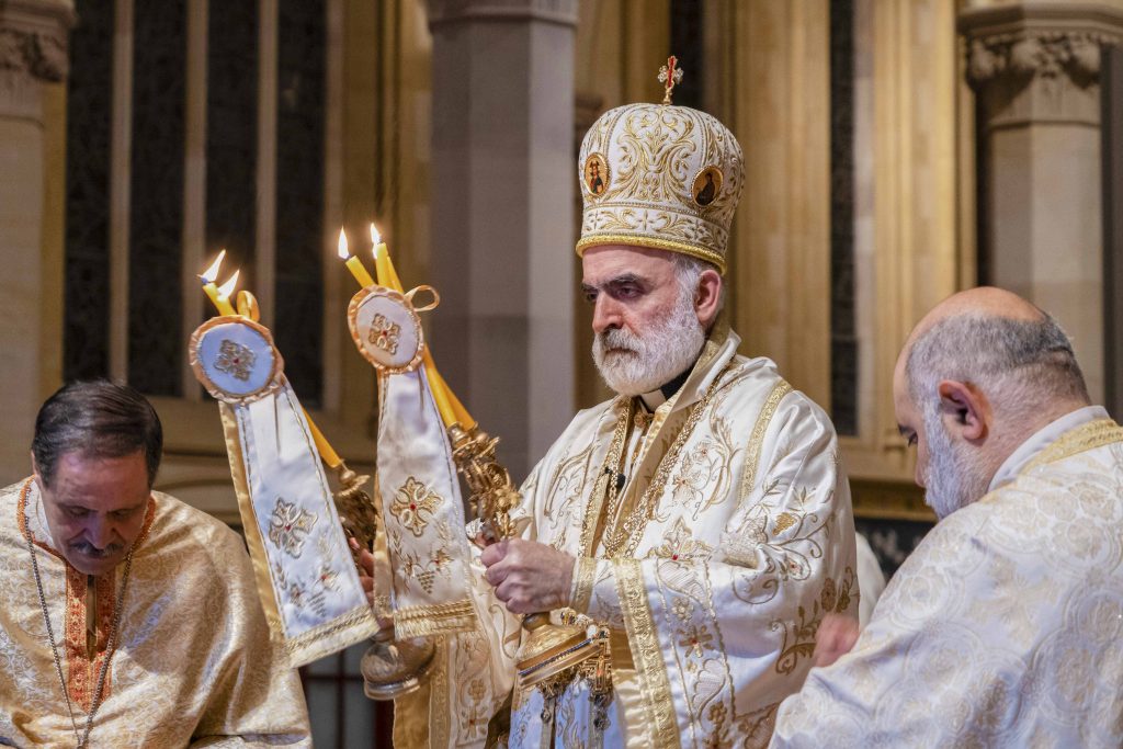At the conclusion of the liturgy on 23 August, Bishop Rabbat offers the Bishop’s Blessing with the Dikirion in his right and Trikirion in his left hand, candles which represent the divinity and humanity of Christ, and the Holy Trinity respectively. Photo: Josh Low.