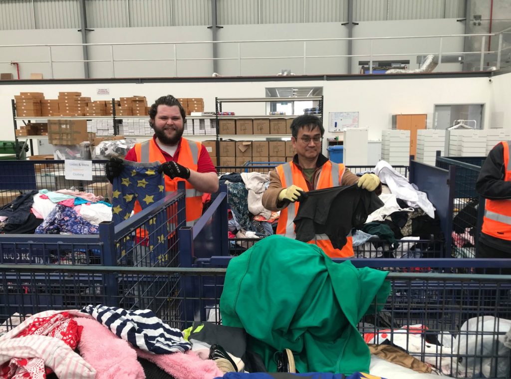 Dane Ehrlich and Hui Bin Loh working at St Vincent de Paul Society as part of the Seton Staff Community Service Day, which was held for the first time on 22 June. Photo: Seton Catholic College.