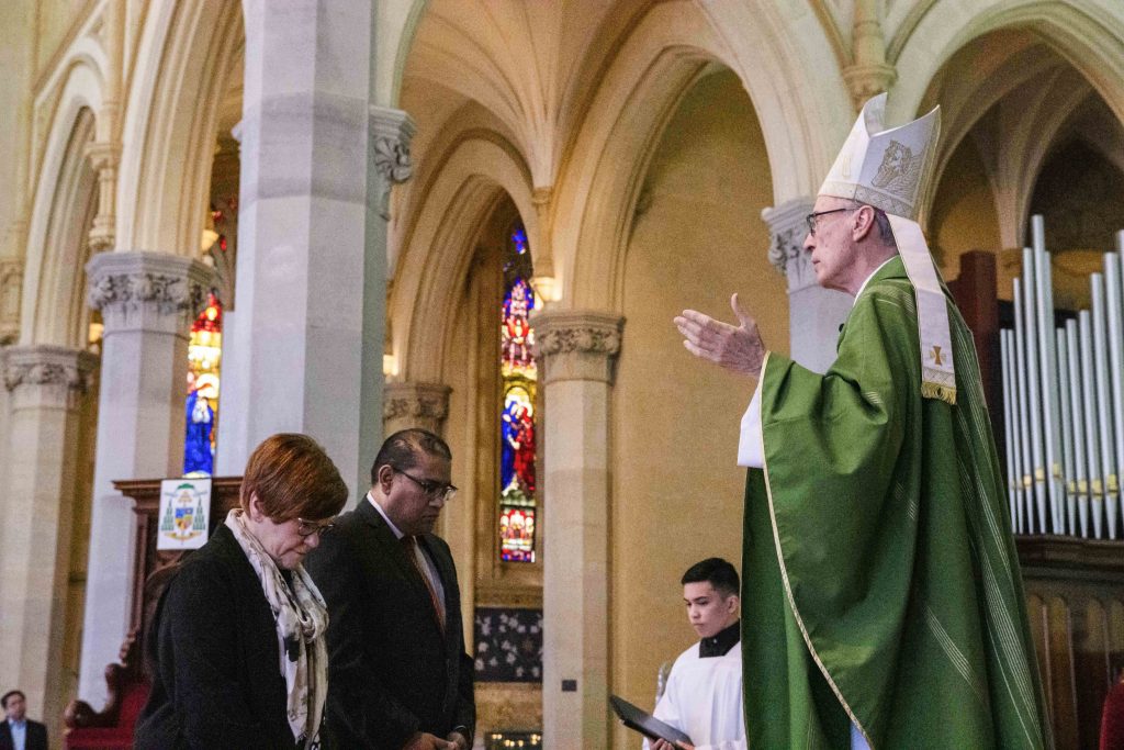 Bishop Sproxton imparts a blessing onto the two new directors of Flame. Photo: Amanda Murthy.