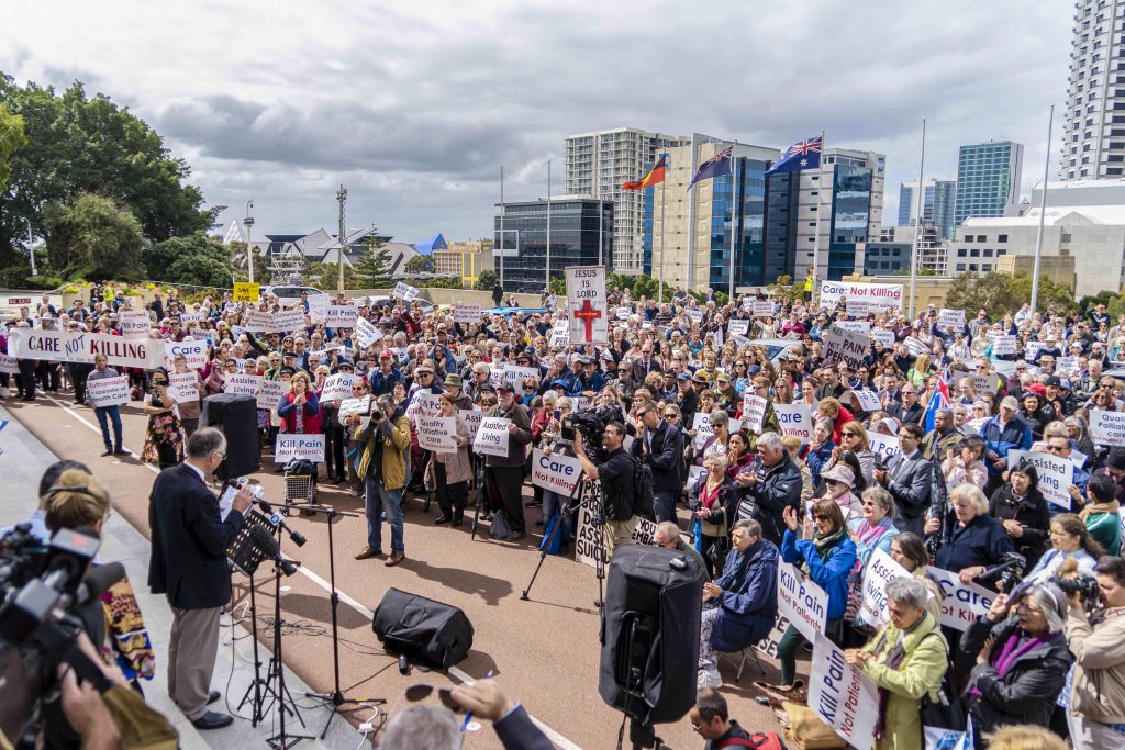 Protestors and supporters gather peacefully outside Parliament House for the 12 noon CARE: Not Kill rally on Wednesday, 4 September. Photo: Josh Low.