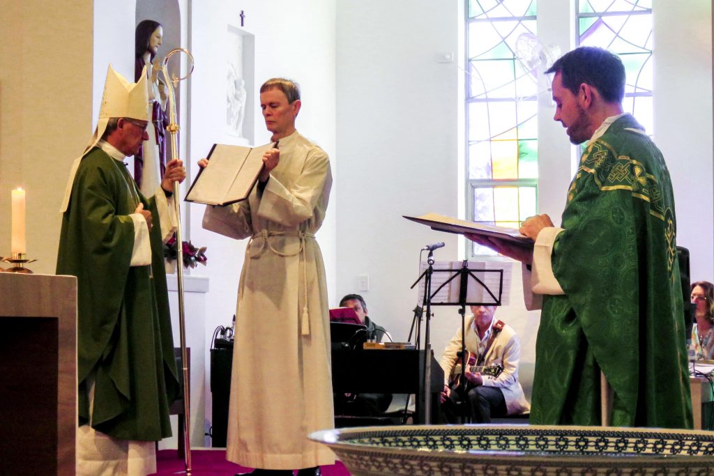 Fr Gorddard makes his Profession of Faith and Oath before the Archbishop as part of the Rite of Installation of a Parish Priest. Photo: Bridget Curran.