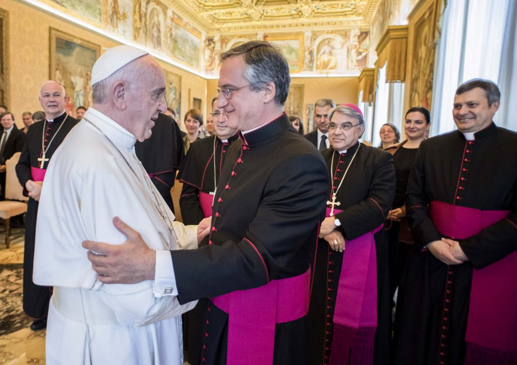 Pope Francis greets Msgr Dario Vigano, Director of the Vatican Secretariat for Communications, during a meeting with members of the Secretariat at the Vatican May 4. Addressing the group responsible for reforming Vatican Communications, the Holy Father said that courageous teamwork is needed to best respond to new challenges. Photo: CNS/L'Osservatore Romano.