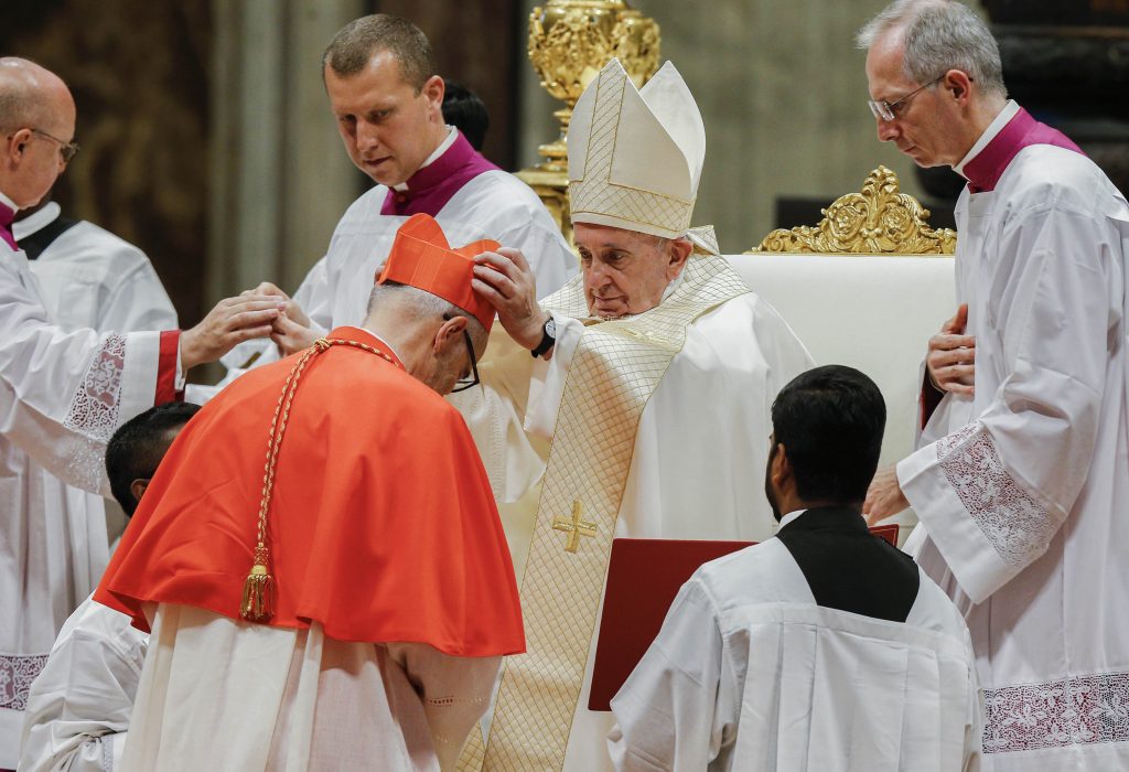 Pope Francis places a red biretta on new Canadian Cardinal Michael Czerny during a consistory for the creation of 13 new cardinals in St Peter's Basilica at the Vatican on 5 October 2019. Photo: Paul Haring/CNS.