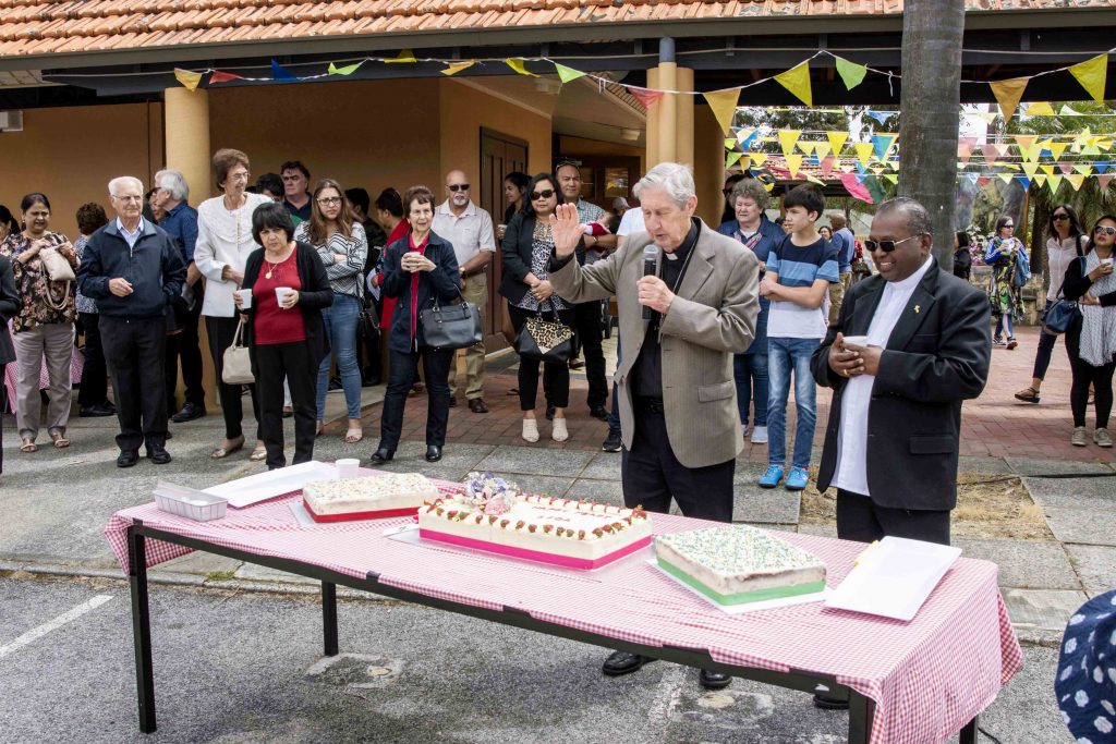 Emeritus Archbishop Barry Hickey blesses the food alongside Maida Vale Parish Priest Fr Joseph Rathnaraj. Photo: Matthew Lau.