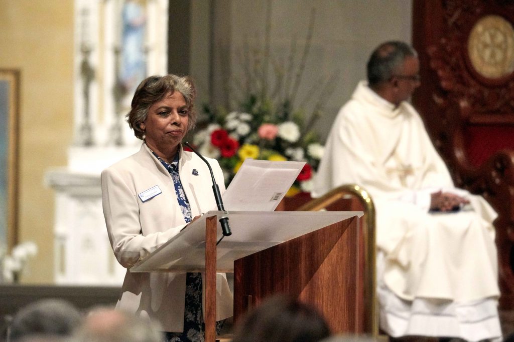 SVDP President Glady Demissie addresses the Venetians, welcoming them to the Thanksgiving Mass. Photo: Ron Tan.